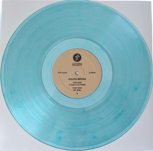 A translucent light blue vinyl record with a beige center label, photographed from above on a white background. The label reads Coco Bryce and includes the track title 'U Can't In There That Side My Girl'.