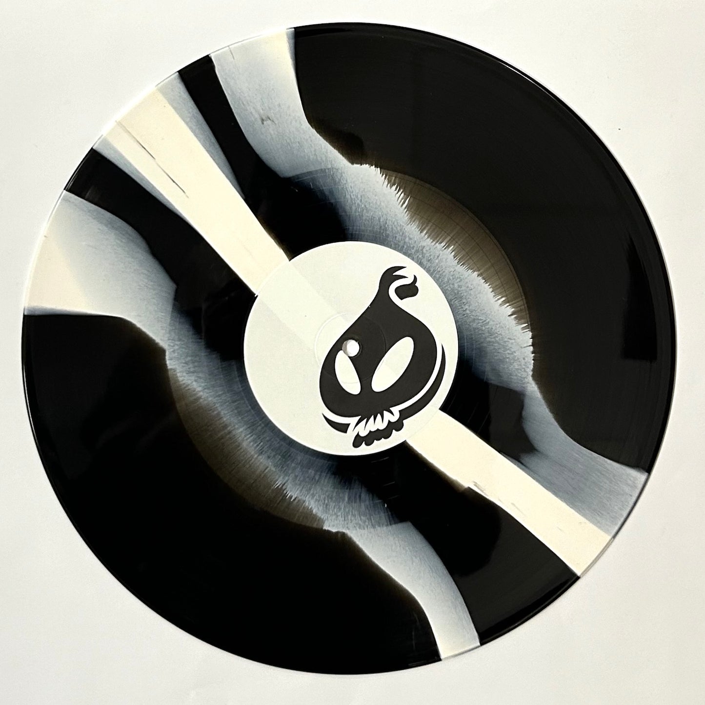 Black and white vinyl record with a logo on a white background
