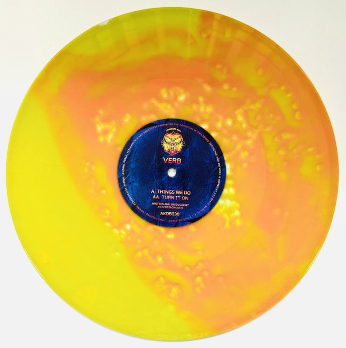 Vinyl record with a colorful marbled design and a blue label on a white background