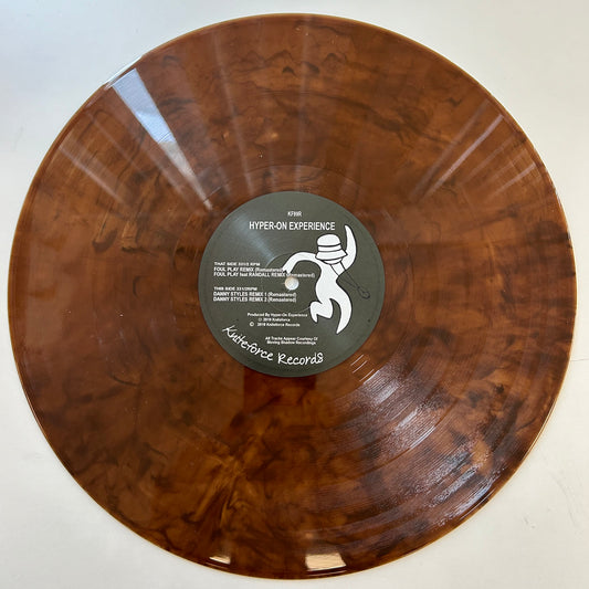 Vinyl record with a brown marbled design and a label on a white background